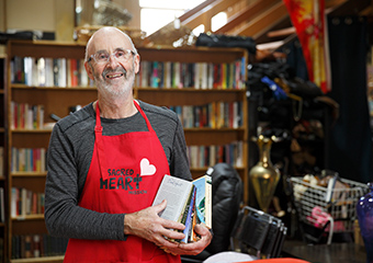 Op shop volunteer putting away books