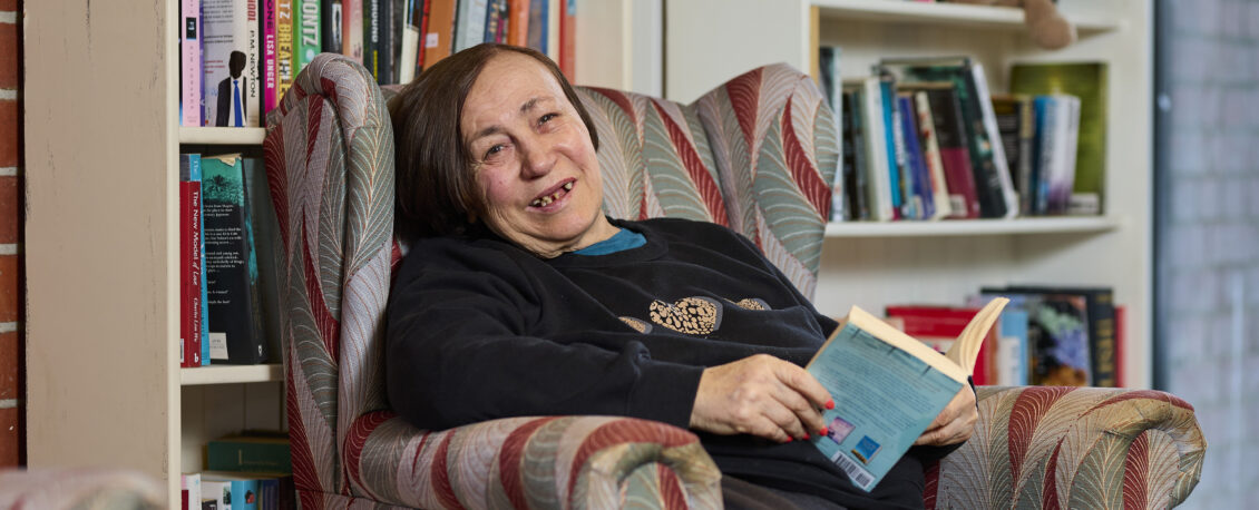 person sitting in a chair with book