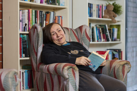 person sitting in a chair with book
